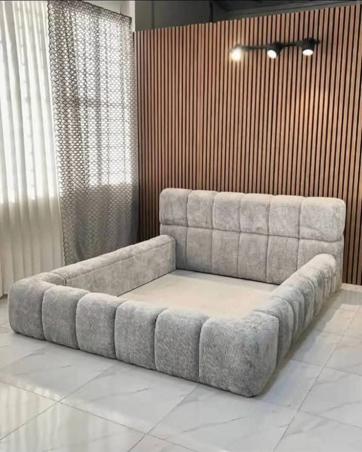 Grey puffy upholstered bed